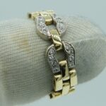 Ein eleganter Hufeisen Goldring in Bicolor mit echten Diamanten